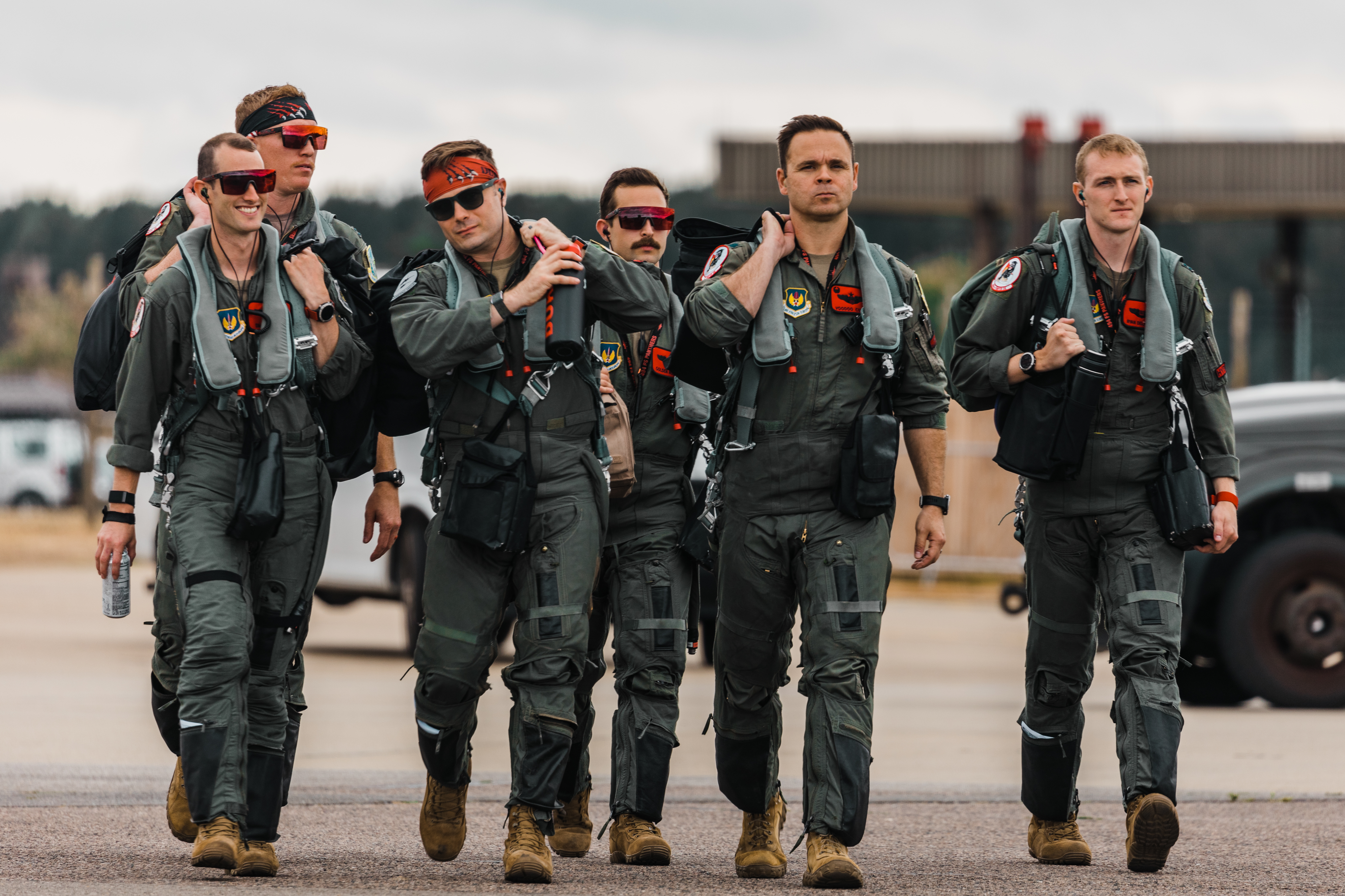 Image shows aviators walking together on the airfield.